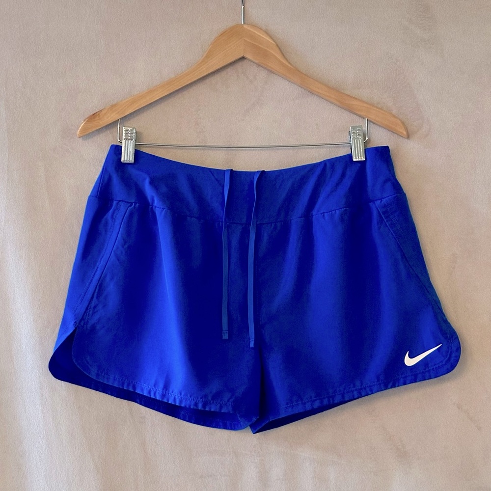 Nike blue dri fit athletic shorts with drawstring and mini pocket. Brief-lined